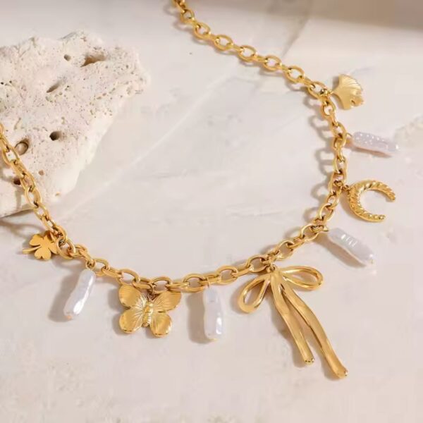 Collar dije acero inoxidable perla mariposa y chongo enchape de oro 18k espectacular